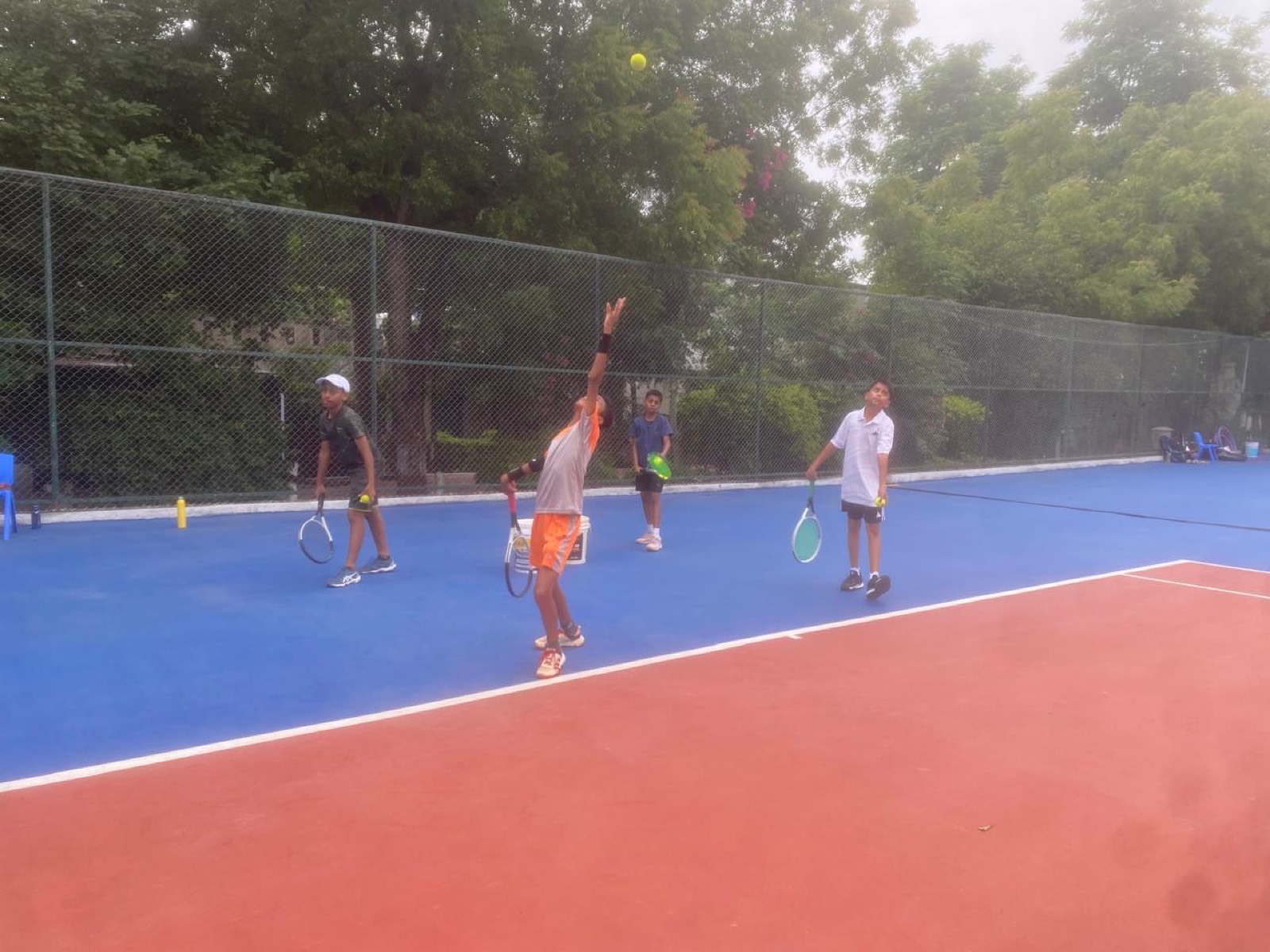 Young players training on the tennis court at DELTSA